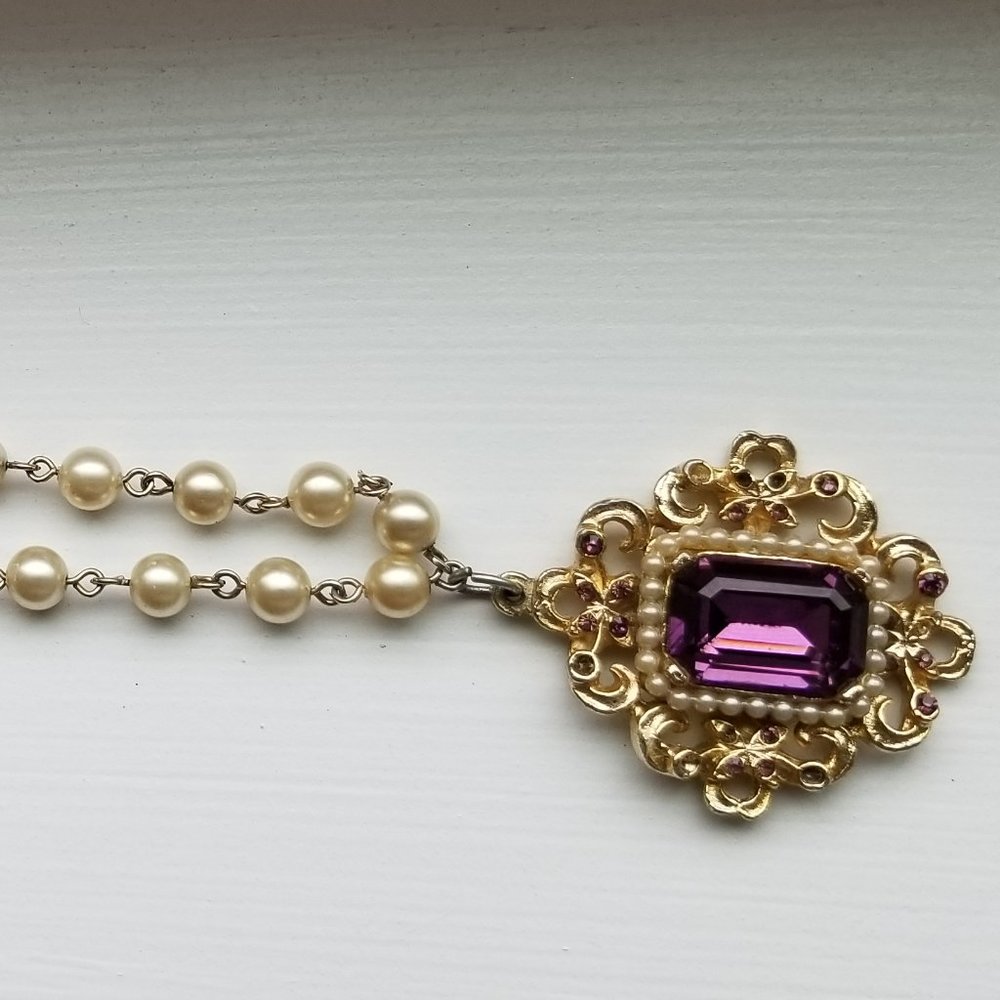costume pearl necklace with purple tone jewel